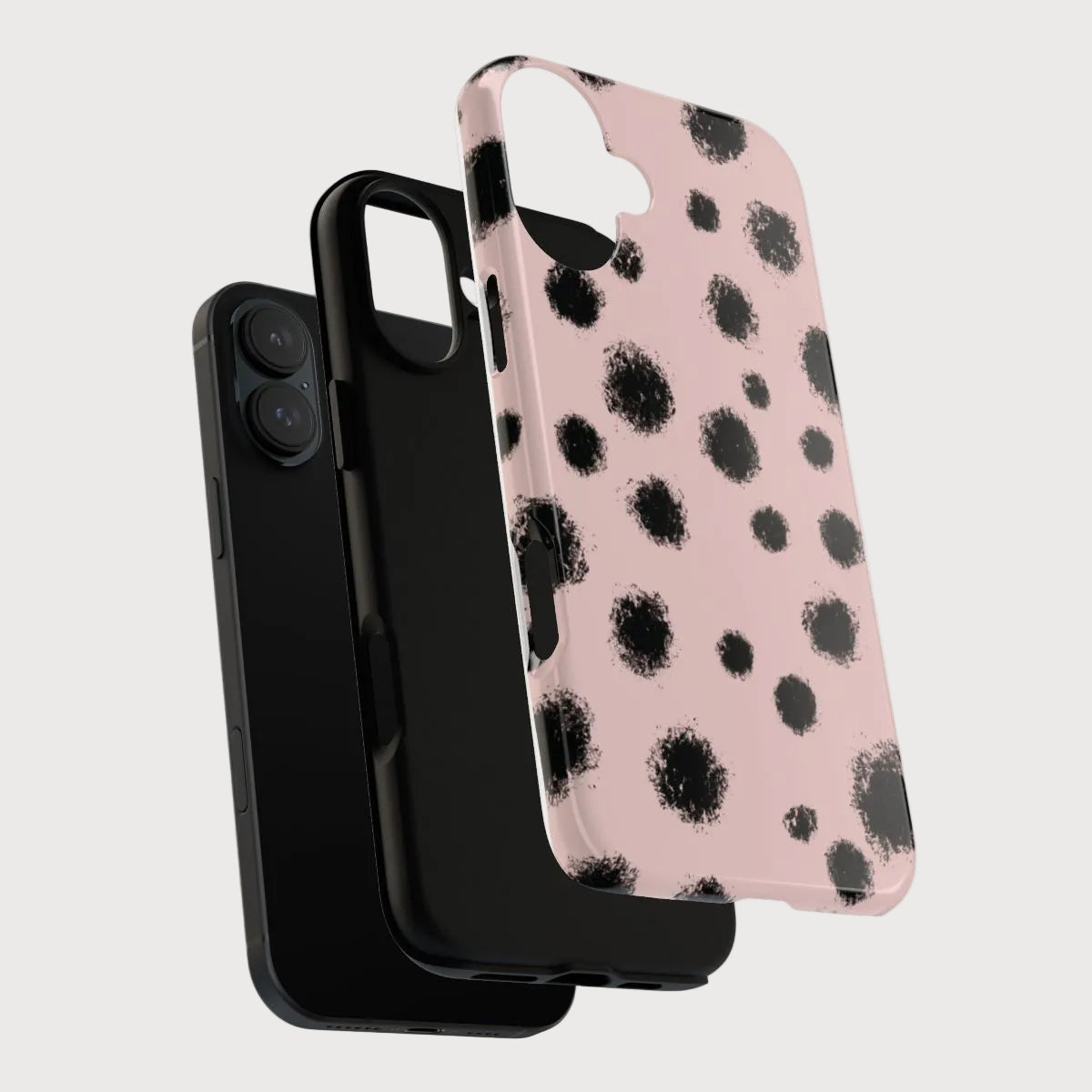 Black phone case with a pink and black polka dot design on a light gray background