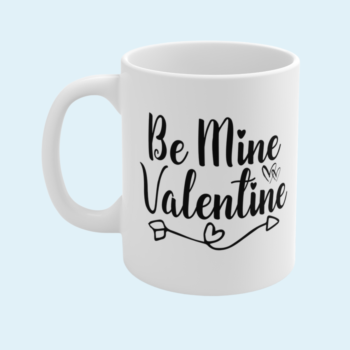 White mug with 'Be Mine Valentine' text on a light blue background