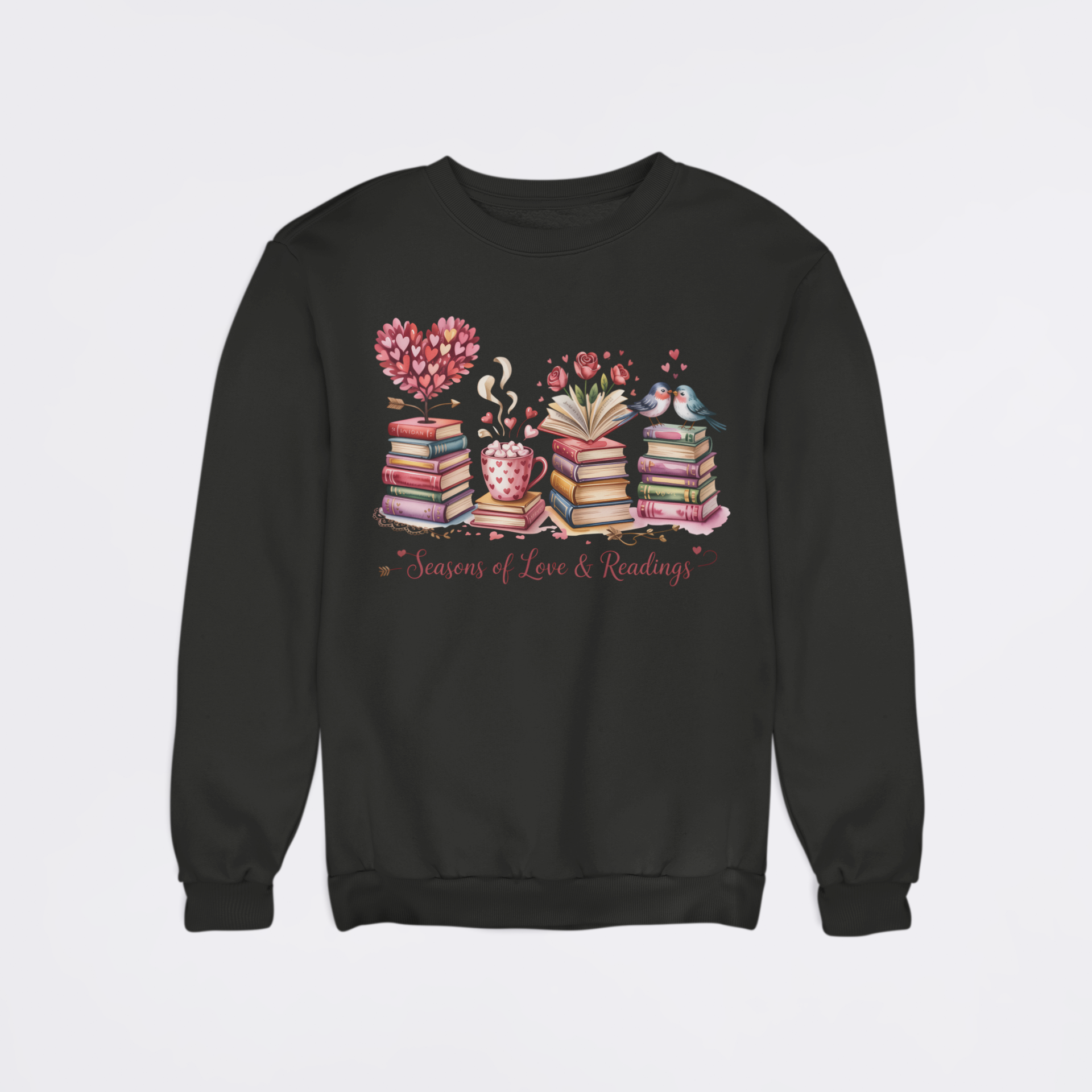 Black sweatshirt with a colorful design of books, a heart, and a teacup on a light gray background.