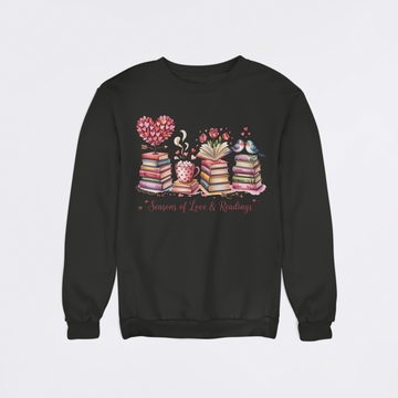 Black sweatshirt with a colorful design of books, a heart, and a teacup on a light gray background.