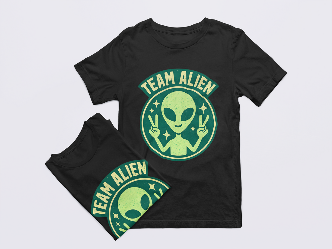 Black t-shirt with green alien graphic and 'Team Alien' text on a light gray background