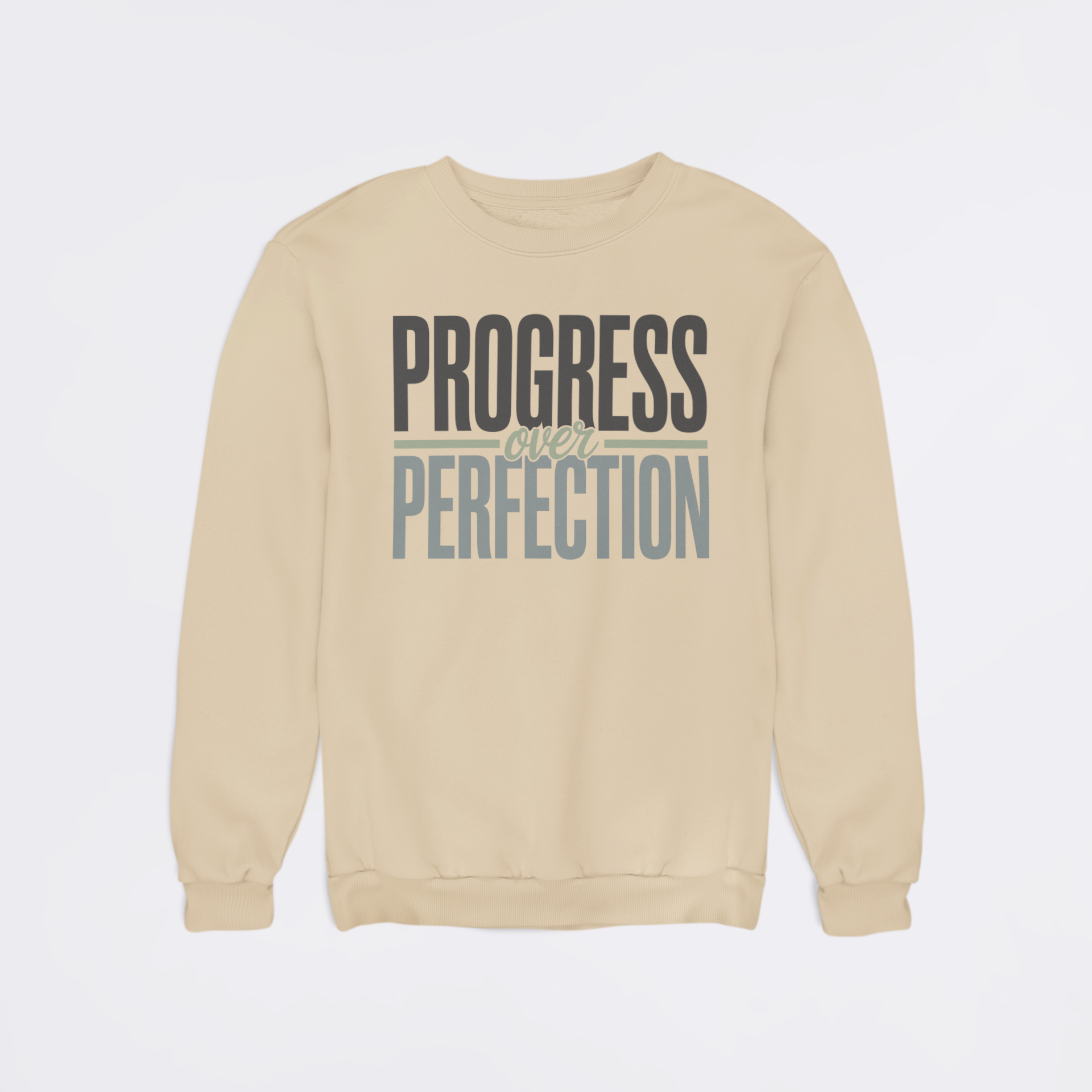 Beige sweatshirt with 'Progress Over Perfection' text on a light gray background
