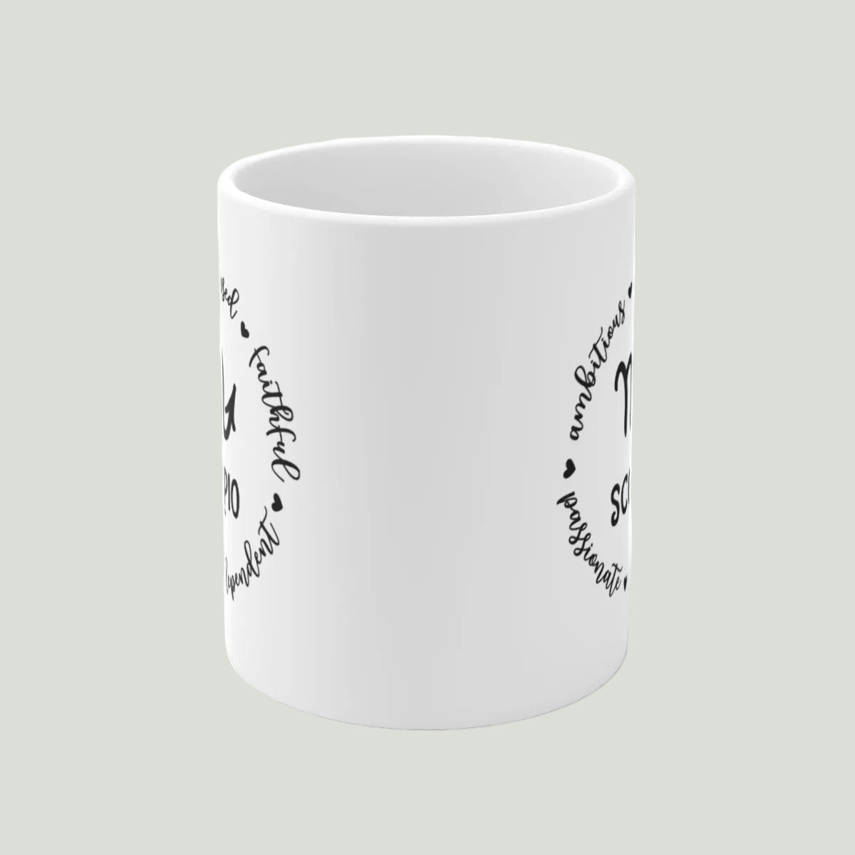 White mug with black text and designs on a light gray background