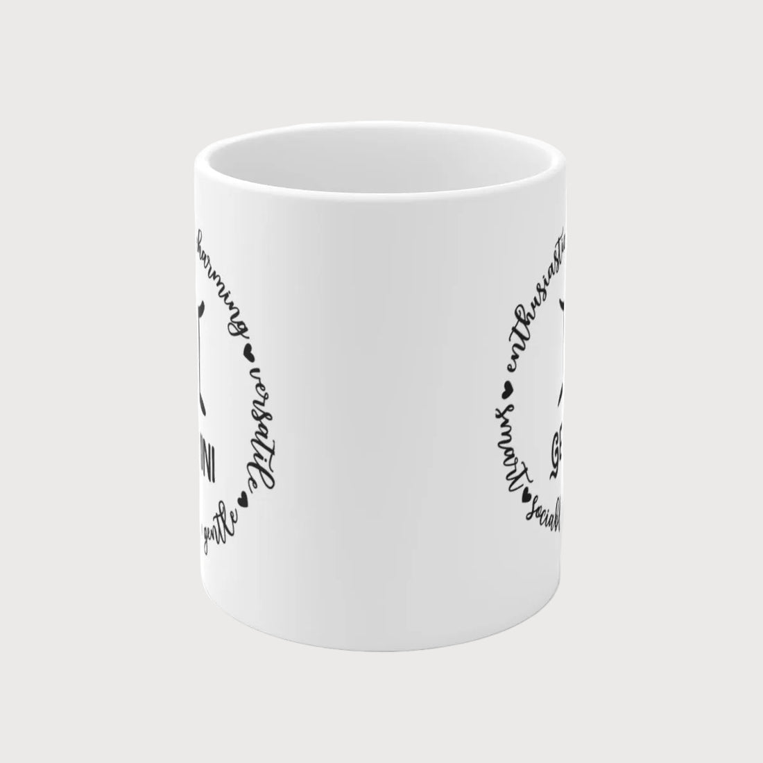 White mug with black Gemini zodiac design on a white background