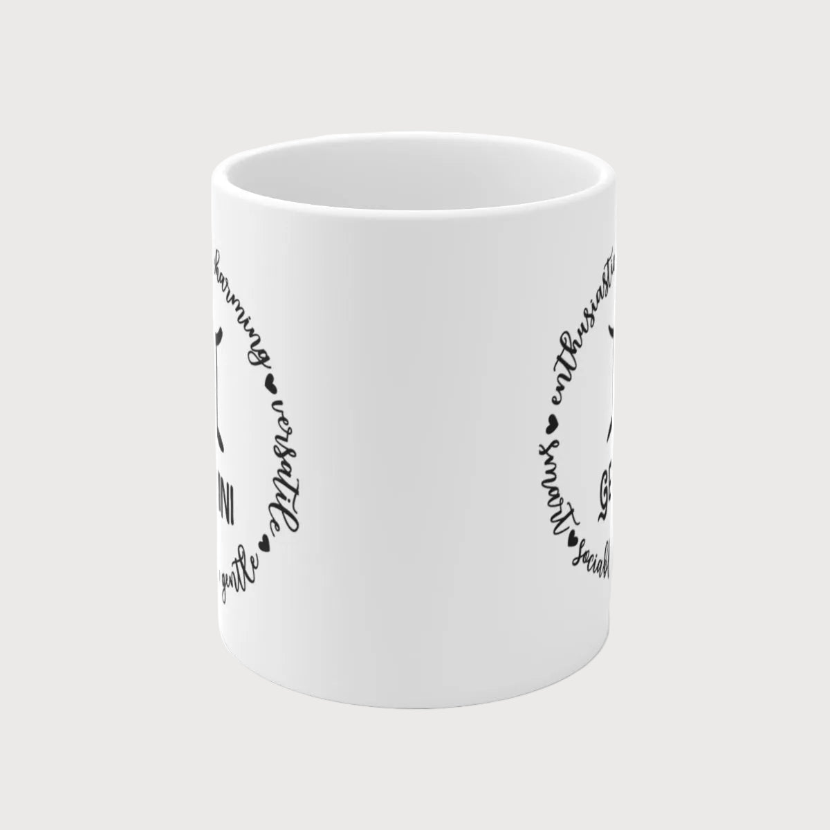 White mug with black text and heart designs on a white background