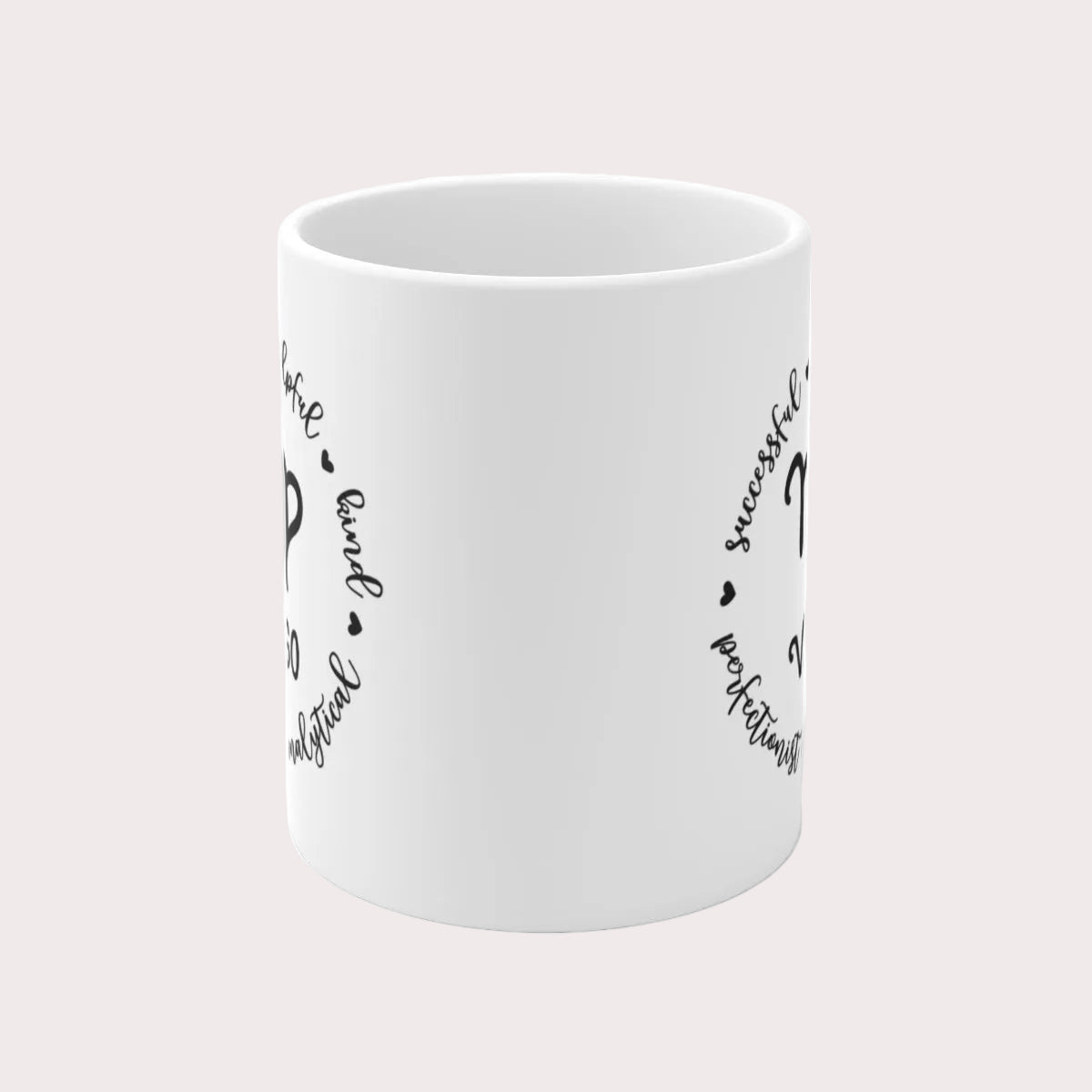 White mug with black text and designs on a light gray background