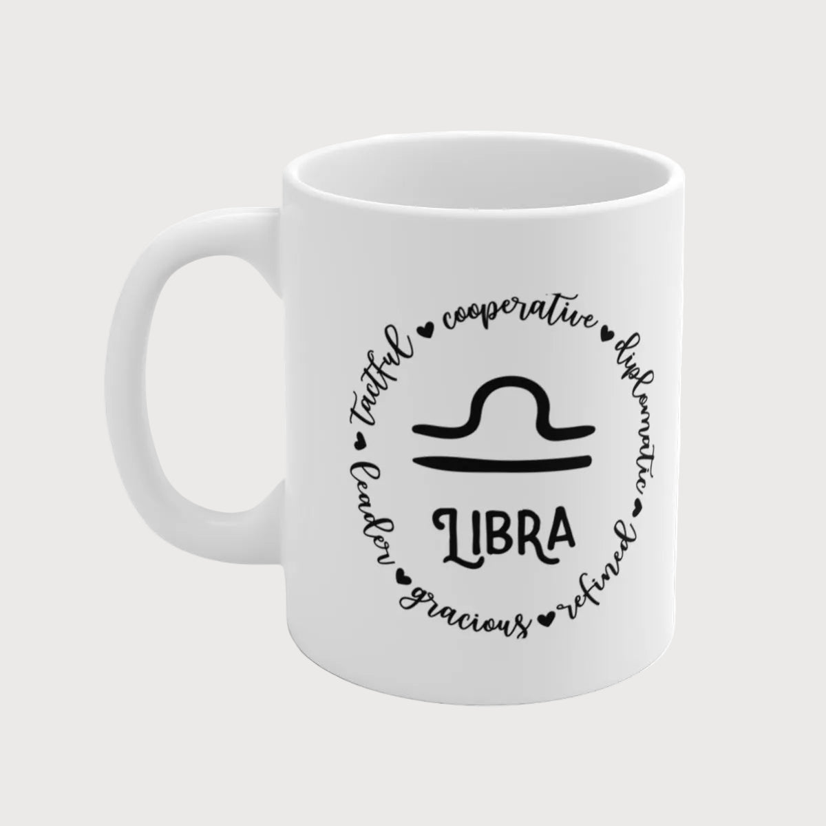 White mug with black text and Libra symbol on a white background