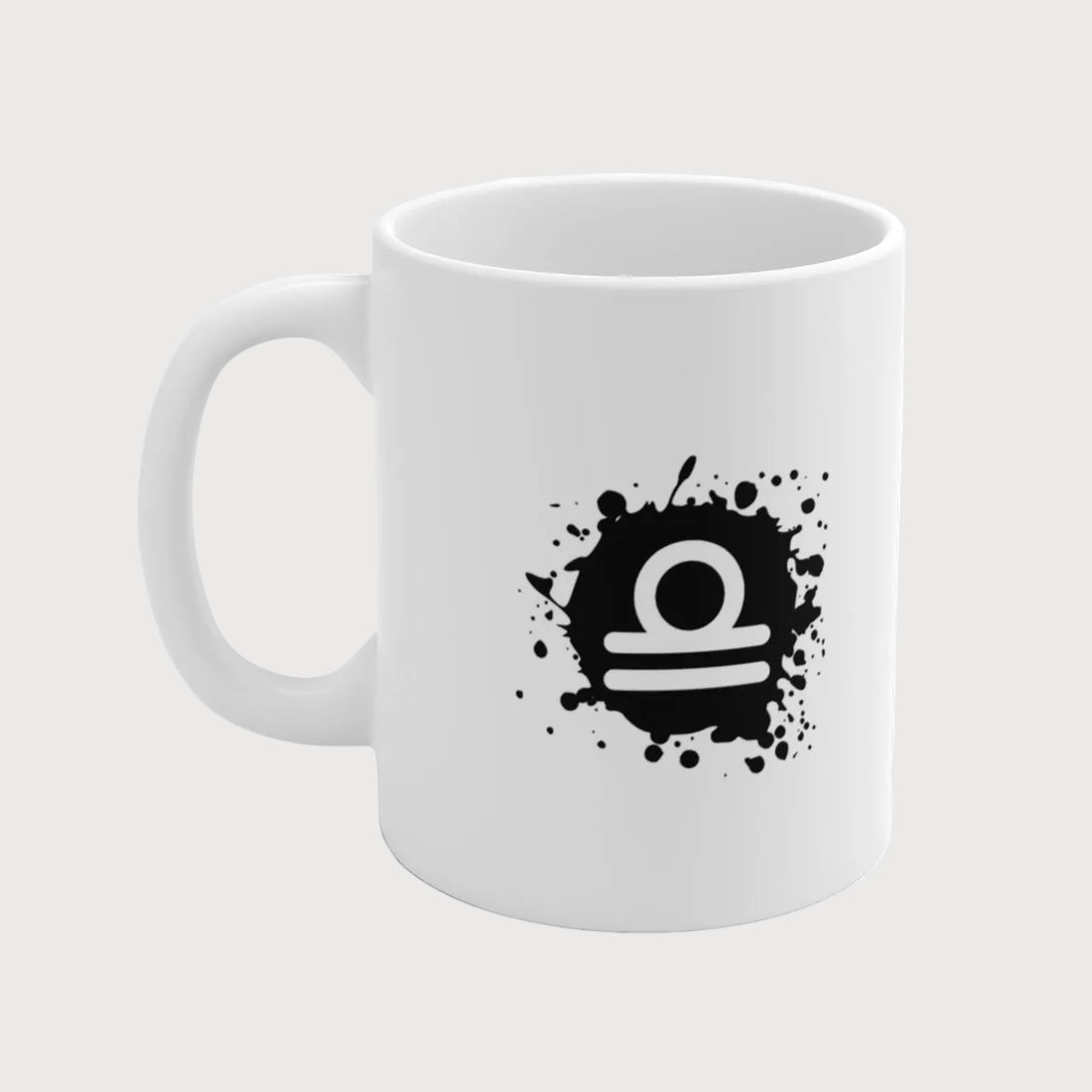 White mug with black Libra zodiac symbol design on a white background